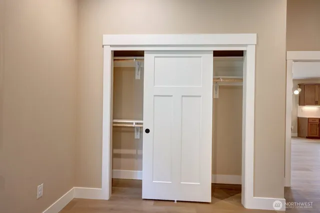 a view of an empty room and closet area