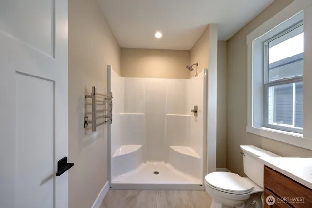 a bathroom with a shower a toilet and a sink