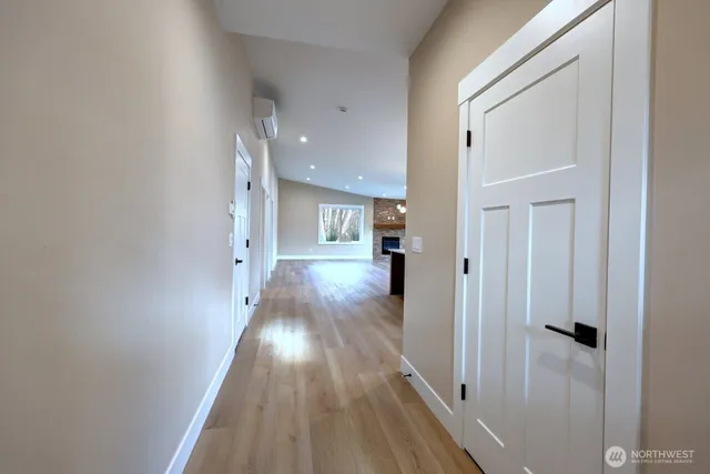 a view of a hallway with wooden floor