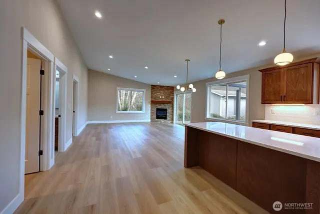 a view of a kitchen with a sink and wooden floor