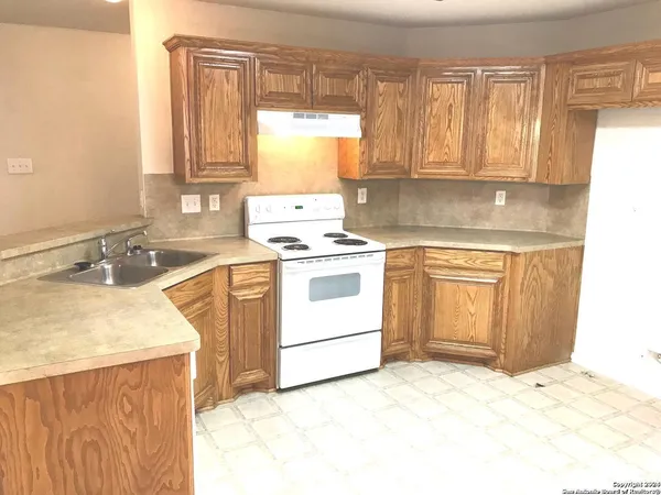 a kitchen with a sink stove and cabinets