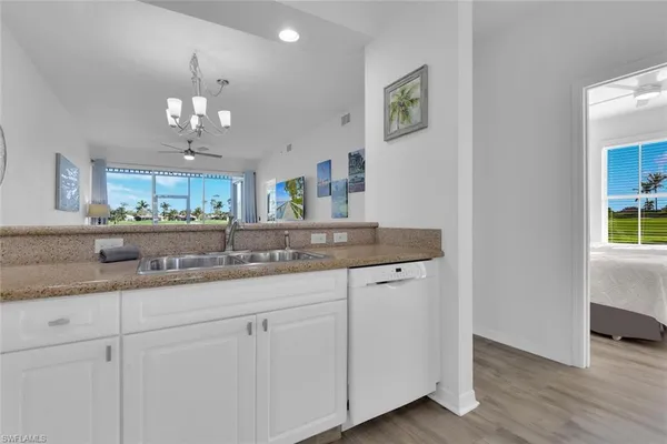 a bathroom with a granite countertop double vanity and a mirror