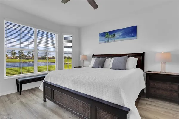 a bedroom with a bed and a large window