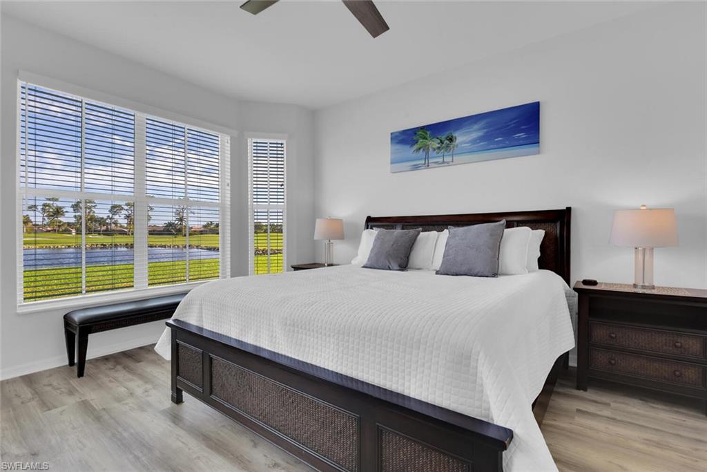 7895 Mahogany Run Lane, Unit 1416 Naples, FL 34113 - Photo 16 of 38 a bedroom with a bed and a large window