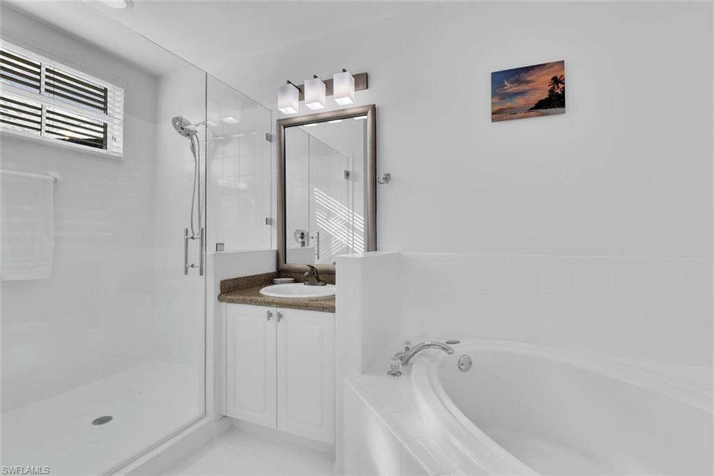 7895 Mahogany Run Lane, Unit 1416 Naples, FL 34113 - Photo 19 of 38 a bathroom with a bathtub and shower