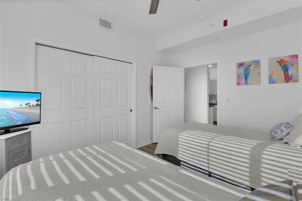 a bedroom with a bed and a flat screen tv