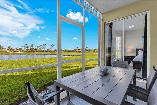 a view of a balcony with chair and floor to ceiling window