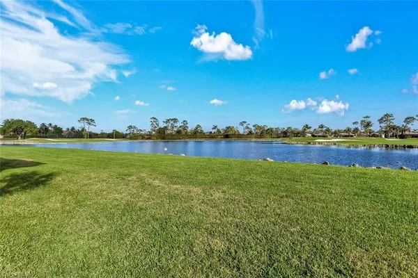 a view of a lake with houses in the back