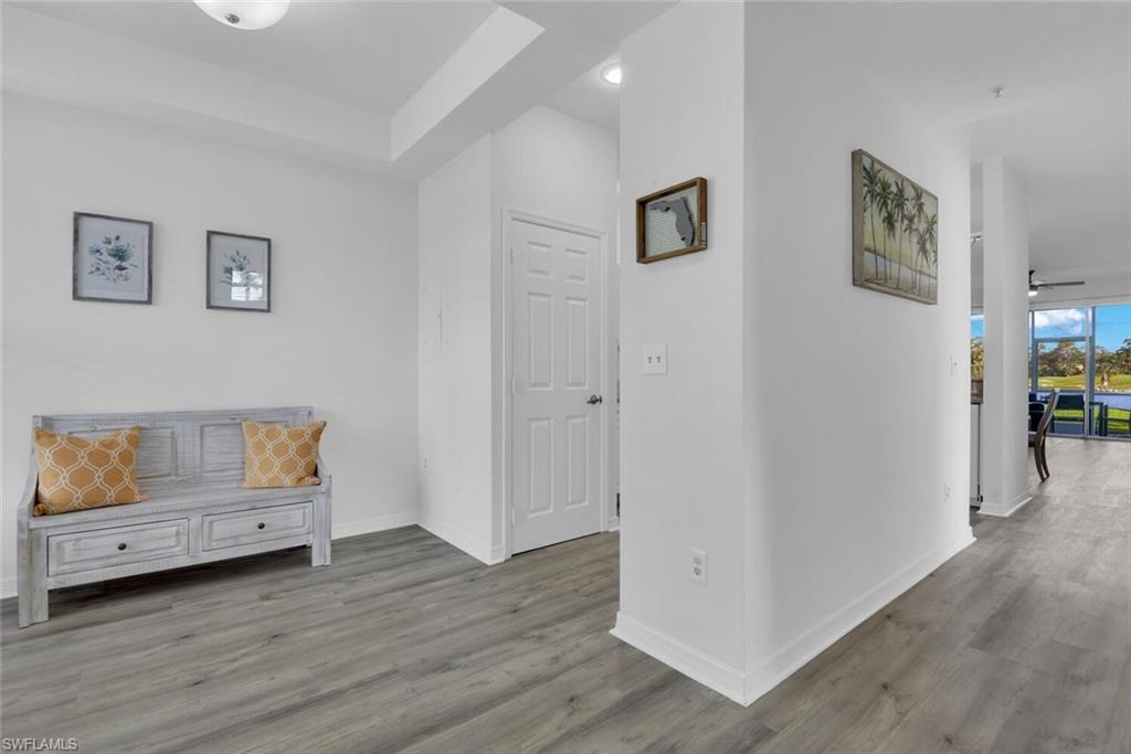 7895 Mahogany Run Lane, Unit 1416 Naples, FL 34113 - Photo 4 of 38 a view of room with furniture and wooden floor