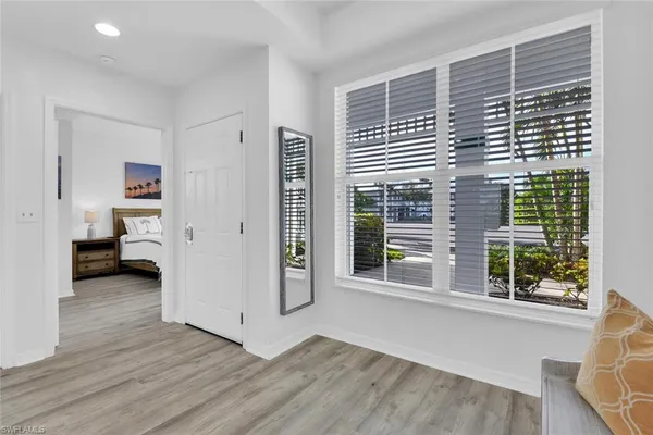 a view of a room with a window and wooden floor