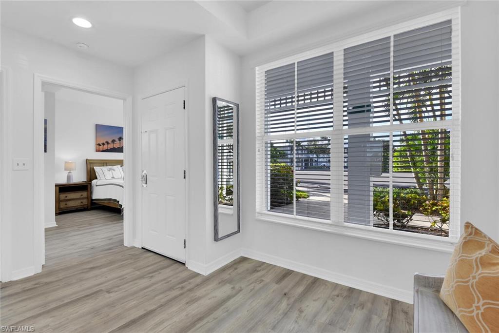 7895 Mahogany Run Lane, Unit 1416 Naples, FL 34113 - Photo 5 of 38 a view of a room with a window and wooden floor
