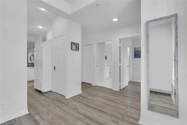 a view of a hallway with wooden floor