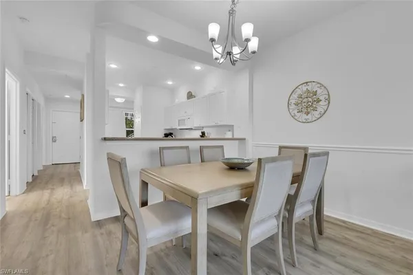 a view of a dining room with furniture and chandelier