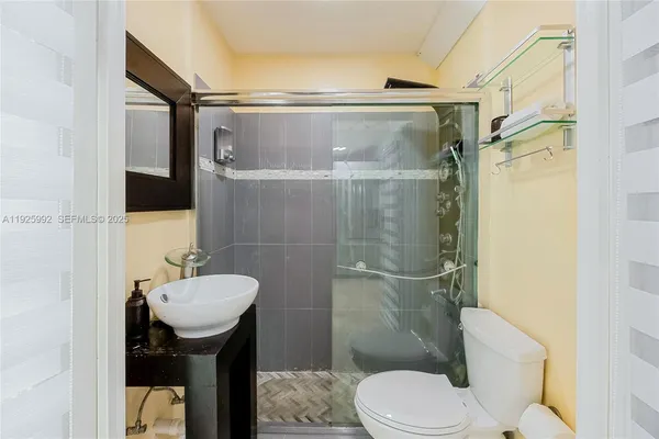 a bathroom with a sink toilet and shower