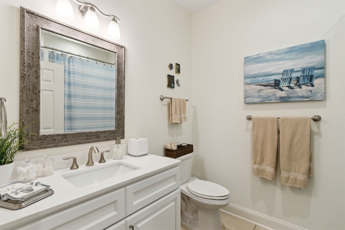 1824 Perimeter Park Road West Fernandina Beach, FL 32034 - Photo 14 of 24 a bathroom with a granite countertop sink mirror vanity and toilet