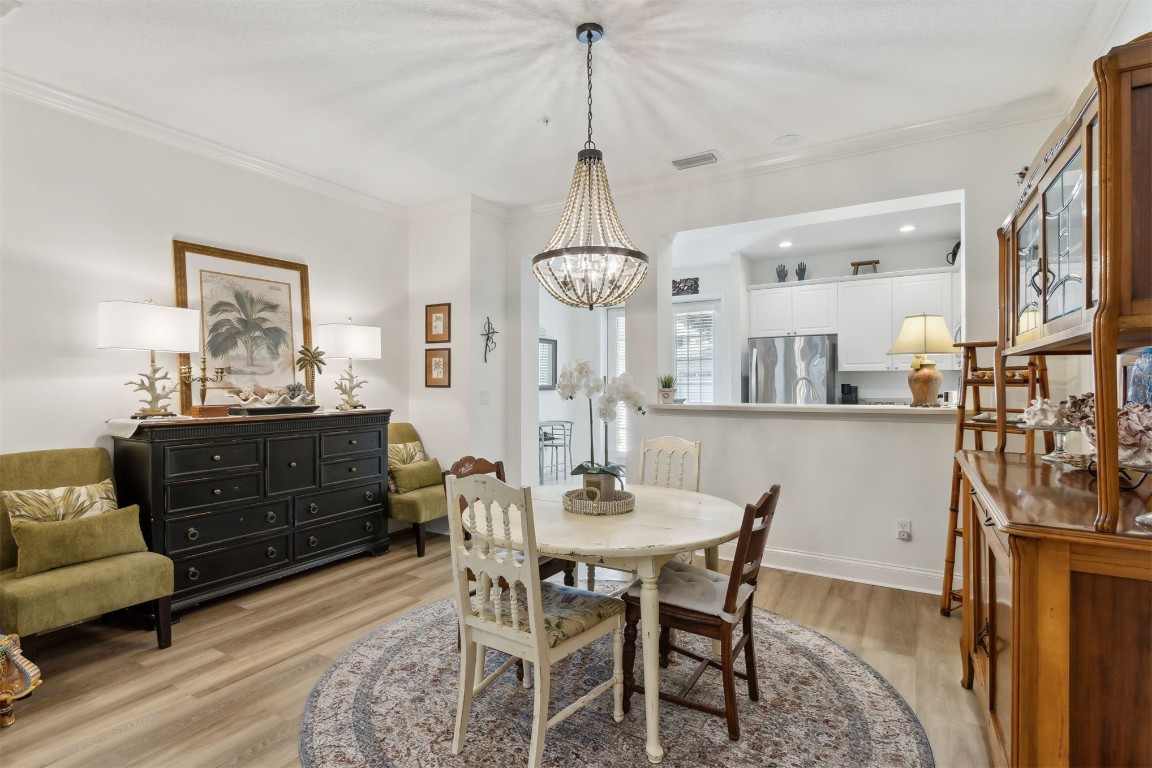1824 Perimeter Park Road West Fernandina Beach, FL 32034 - Photo 5 of 24 a view of a dining room with furniture and wooden floor