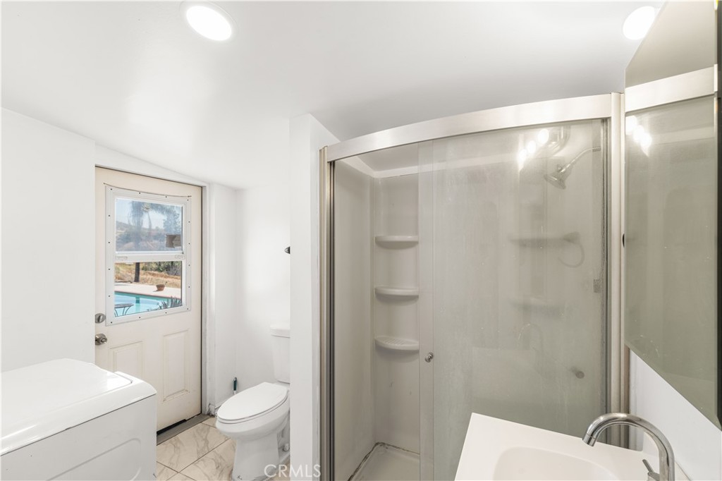 6308 Hawarden Drive Riverside, CA 92506 - Photo 29 of 37 a bathroom with a shower a toilet and a sink
