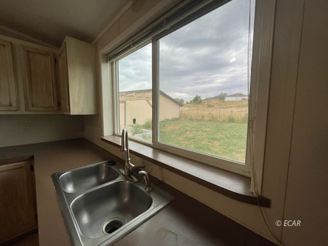 473 Spring Valley Parkway Spring Creek, NV 89815 - Photo 9 of 40 a bathroom with a sink and a window