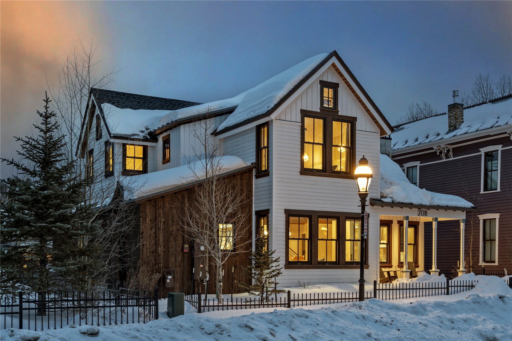 a front view of a house with glass windows and brick walls