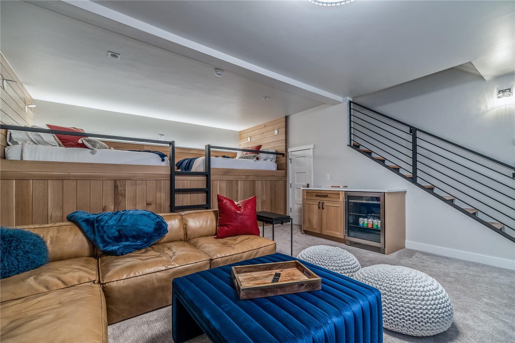 208 North Ridge Street Breckenridge, CO 80424 - Photo 15 of 34 The lower-level suite is currently configured as a bedroom and flex space, featuring two full mattresses and a comfortable family TV roomideal for guests, kids, or multi-generational living. For those looking to maximize sleeping capacity, this space can easily be reconfigured to accommodate bunk beds, increasing sleeping options while preserving the homes high-end design.