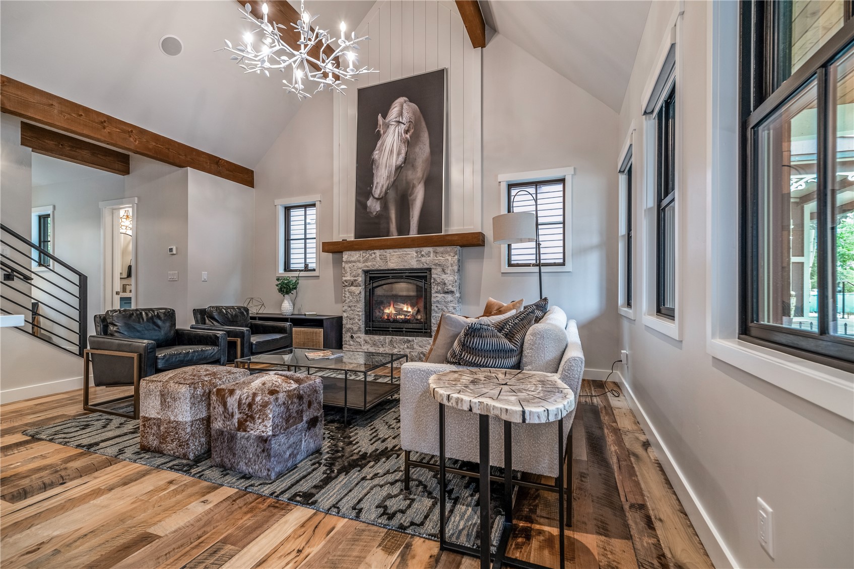 208 North Ridge Street Breckenridge, CO 80424 - Photo 6 of 34 The great room commands attention with vaulted ceilings, rich wood accents, and a stone fireplace that grounds the space in warmth and craftsmanship.