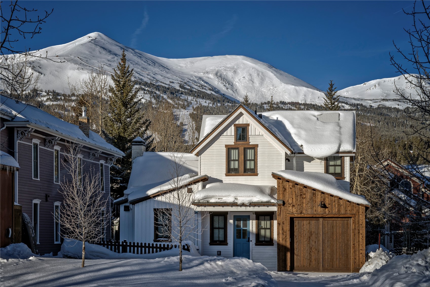 208 North Ridge Street Breckenridge, CO 80424 - Photo 8 of 35 a view of a white house with a large tree and wooden fence