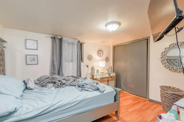 a bedroom with a large bed and a dresser