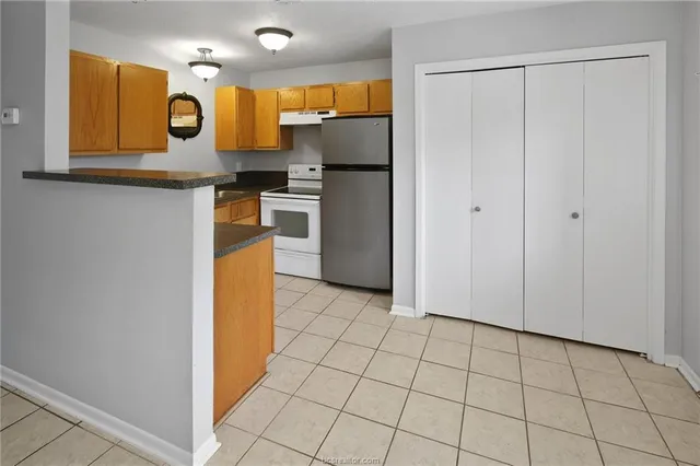 a kitchen with stainless steel appliances a refrigerator and microwave