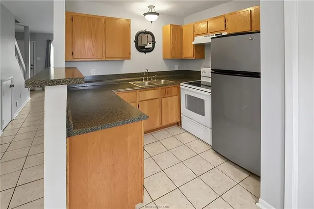a kitchen with a white cabinets and white appliances