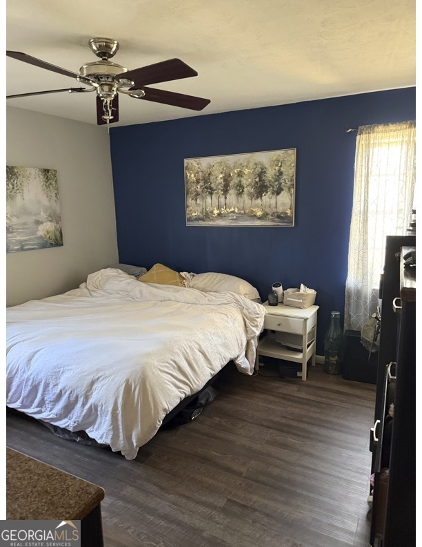 725 Strickland Town Road Luthersville, GA 30251 - Photo 14 of 18 a bedroom with a bed and a painting on the wall