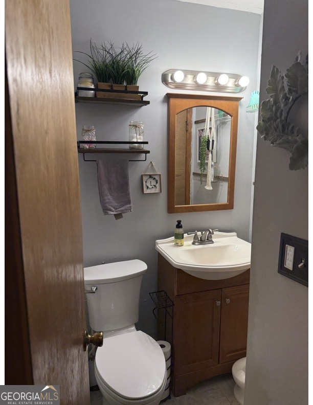 725 Strickland Town Road Luthersville, GA 30251 - Photo 15 of 18 a bathroom with a toilet sink and mirror