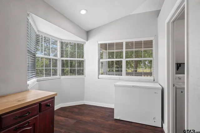 a view of a room with wooden floor and windows