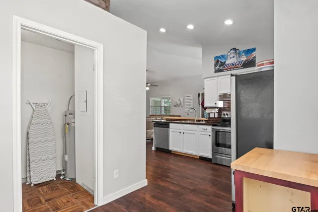 a kitchen with a refrigerator and a stove top oven