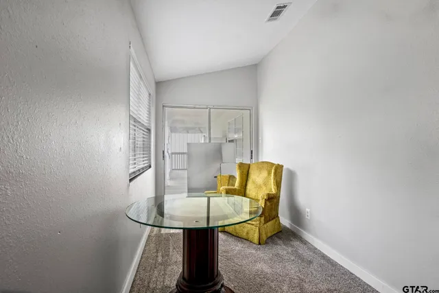 a view of a room with a table and chairs