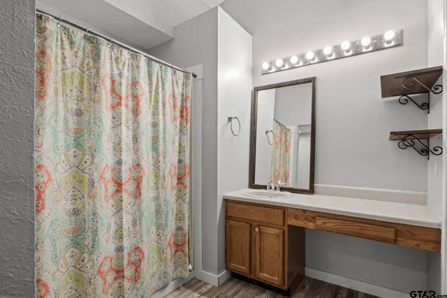 a bathroom with a double vanity sink and a mirror