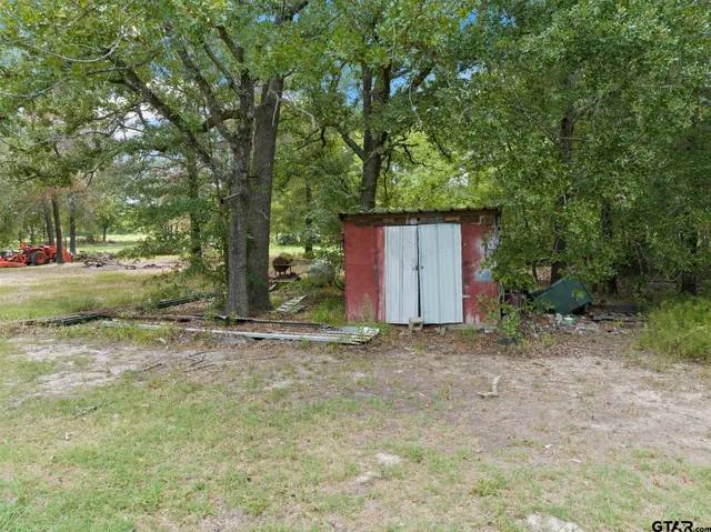 a backyard of a house with plants and trees