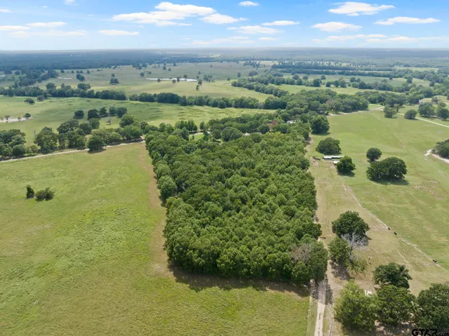 an aerial view of ocean with residential houses with outdoor space