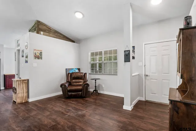 a living room with furniture and a mirror
