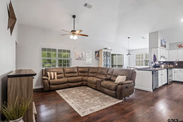 a living room with furniture and a chandelier
