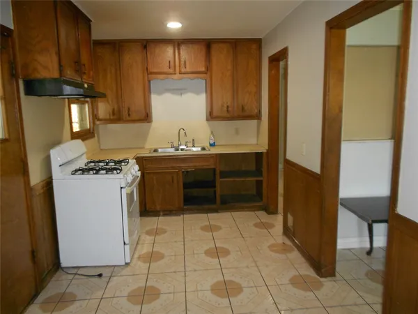 a kitchen with a sink a stove and a refrigerator