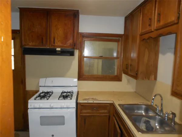 a kitchen with a sink a stove and cabinets