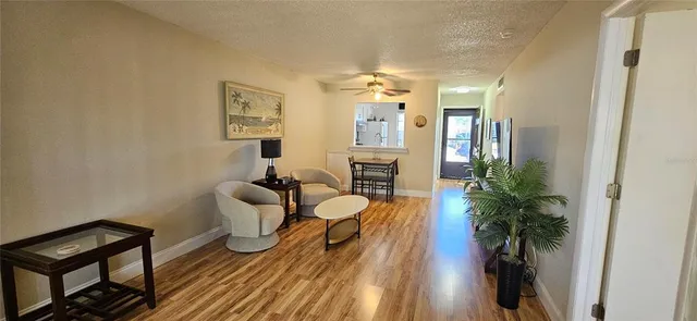 a living room with furniture and a potted plant