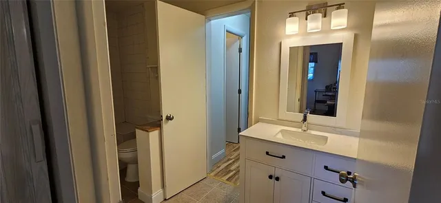 a bathroom with double vanity sinks and a mirror
