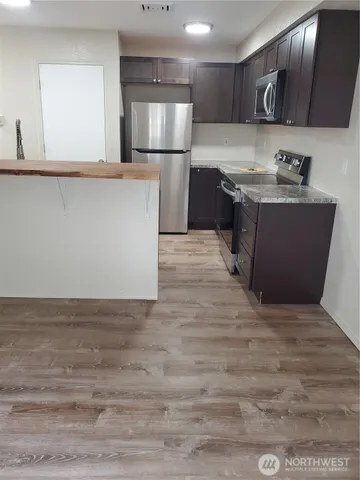 a kitchen with sink and cabinets