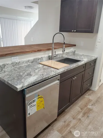 a view of room with wooden floor and flat screen tv