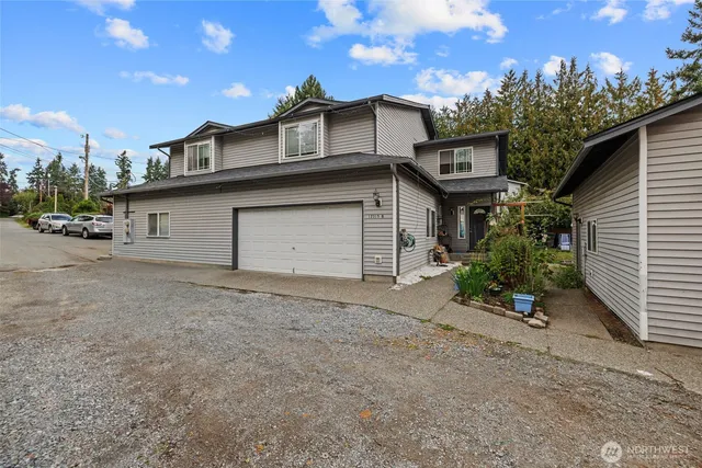 a view of a house with a yard and garage
