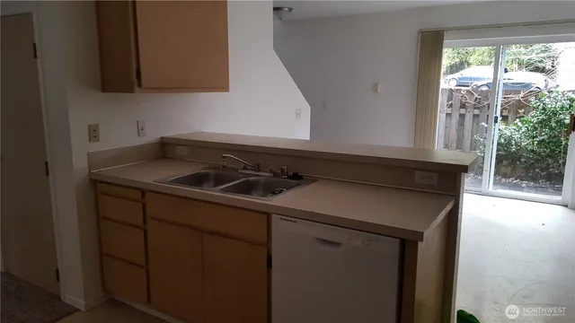 a utility room with sink dryer and washer