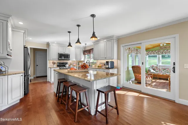 a view of entryway livingroom and hall with wooden floor