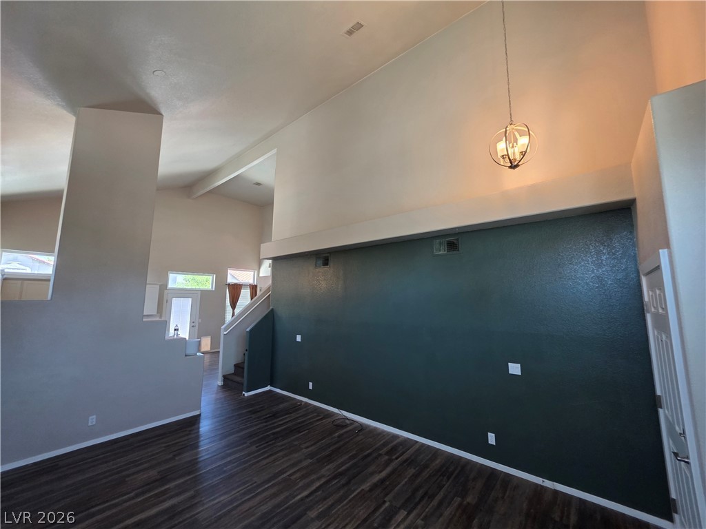 2275 Ramsgate Drive Henderson, NV 89074 - Photo 29 of 84 Dramatic vaulted ceilings create an airy ambiance in this generously sized living space, featuring rich hardwood-style flooring.