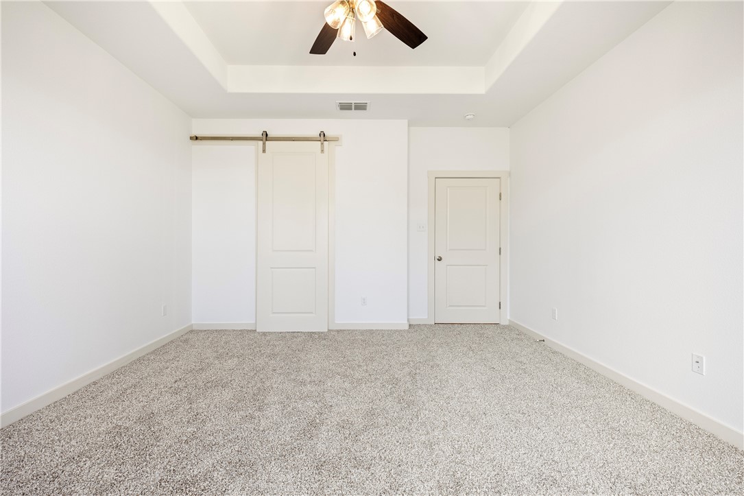 1702 Elm View Drive Corpus Christi, TX 78418 - Photo 11 of 27 an empty room with a ceiling fan and a window